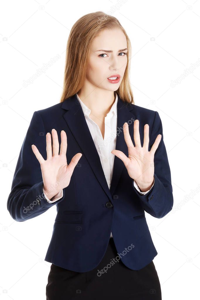 Beautiful caucasian business woman is showing refusing, rejecting gesture.