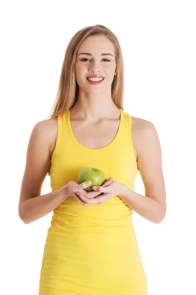 Beautiful casual caucasian woman holding fresh green apple. — Stock Photo, Image