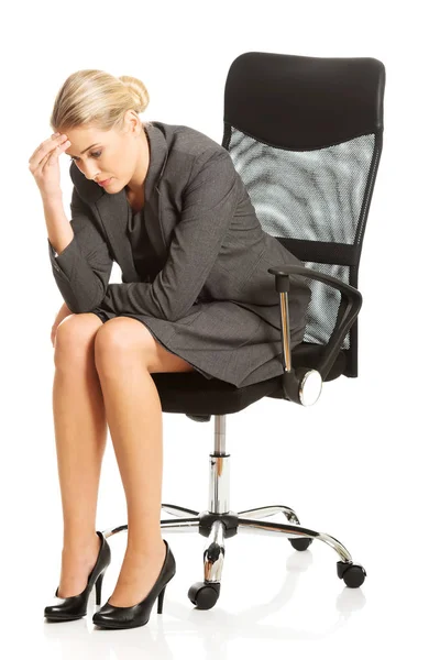 Depressed businesswoman sitting on armchair — Stock Photo, Image