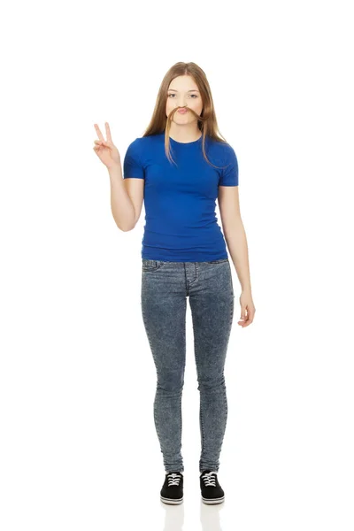 Teenager making moustache from hair. — Stock Photo, Image