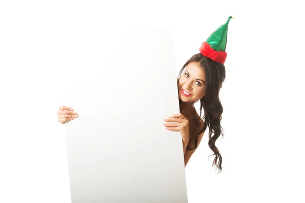 Woman wearing elf clothes hiding behind white banner, looking at the camera — Stock Photo, Image