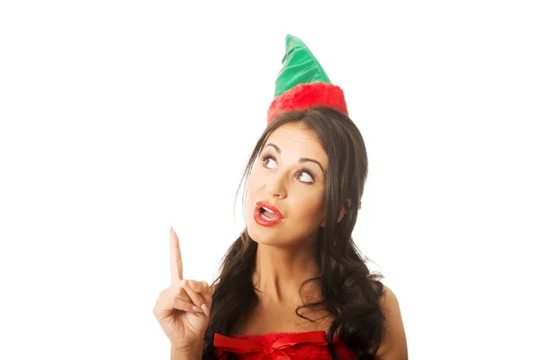 Surprised woman wearing elf clothes pointing up — Stock Photo, Image