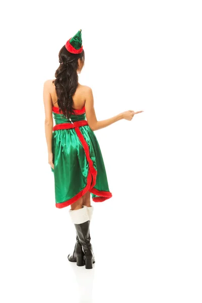 Vista posteriore della donna che indossa vestiti da elfo che punta a destra — Foto Stock
