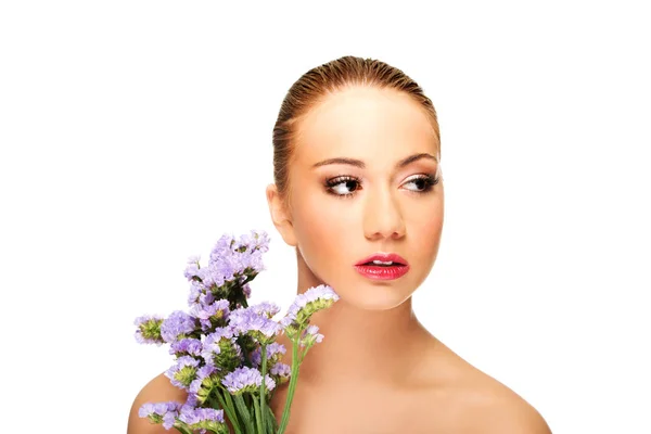 Sensual young spa woman holding flower. — Stock Photo, Image