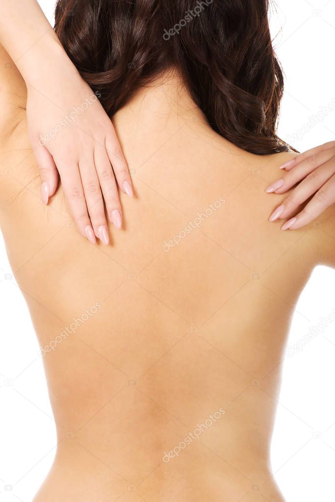 Woman holding her back in pain.