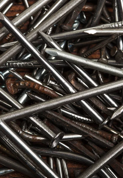 Pile of metal nails on wooden background — Stock Photo, Image