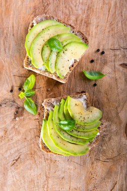 Avokado dilimleri ve fesleğen ile sandviç