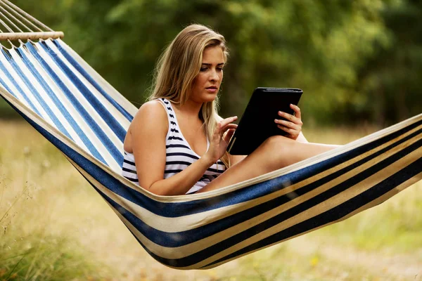 Young woman with tablet on the hammock — Stock Photo, Image