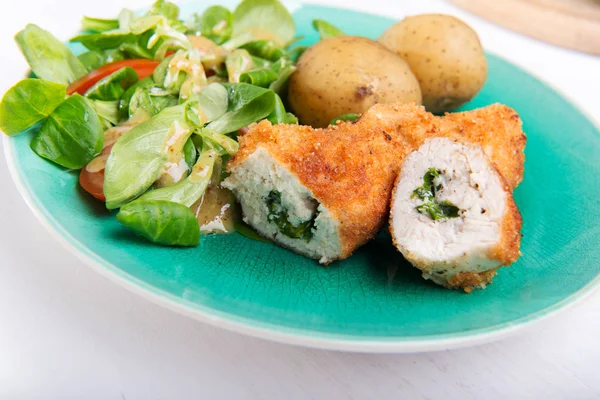 Kiev cutlet with jacket potatoes and salad