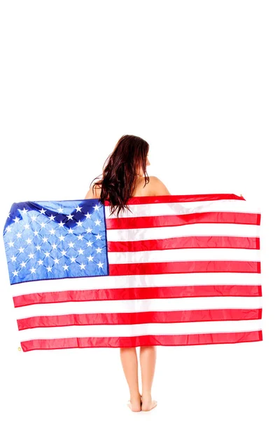 Beautiful brunette woman wrapped into American flag. Stock Picture