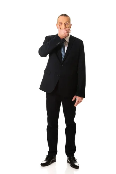Businessman covering his mouth — Stock Photo, Image
