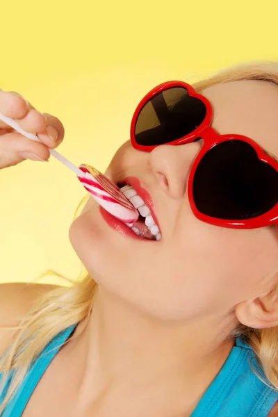 Young happy woman holding lollipop — Stock Photo, Image