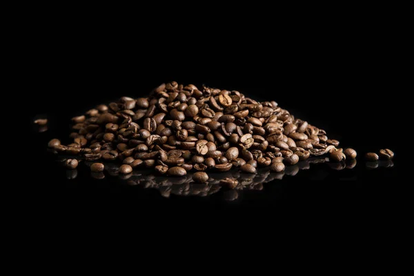 Heap of coffee seed on black background