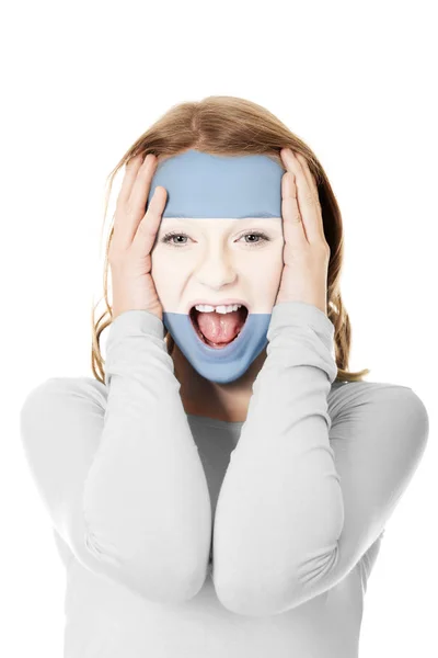 Woman with the argentinean flag on face. — Stock Photo, Image