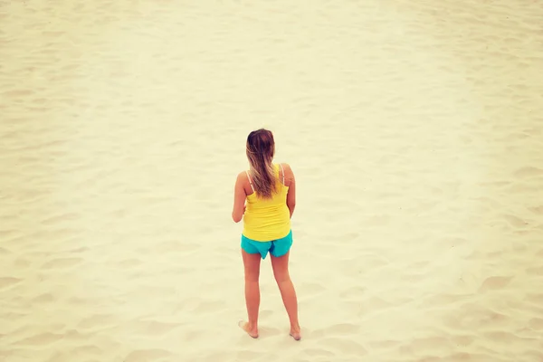 Tired woman standing on the beach — Stock Photo, Image