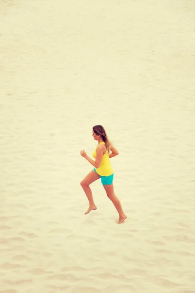 Giovane donna che corre sulla spiaggia — Foto Stock