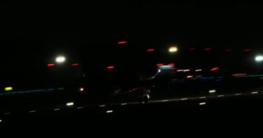 White aircraft takes off from the airport Runaway in the night. Airplane front view.