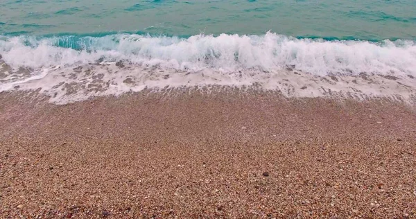 Soft wave on pebbles beach — Stock Photo, Image