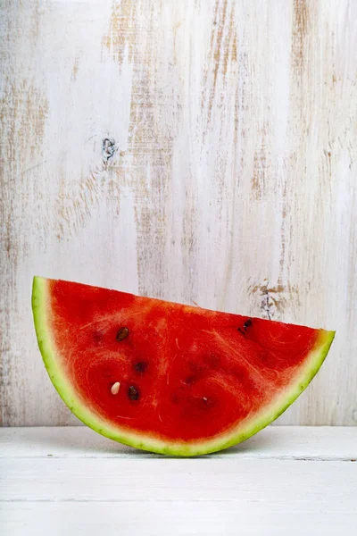 Karpuz ahşap bir masa üzerinde parçası. Lezzetli tatlı.