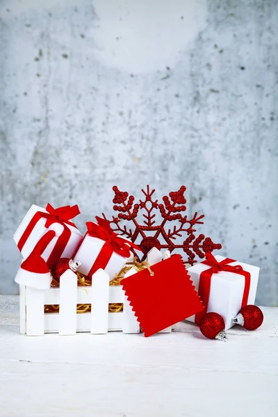 Christmas gifts and decorations in a white box on a grunge background. Christmas sale.
