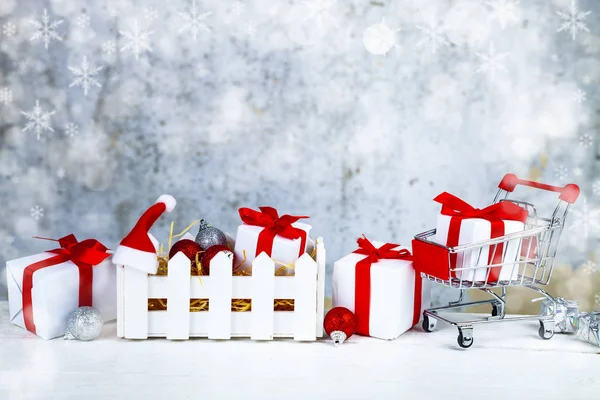 Christmas gifts and decorations in a white box on a grunge background. Christmas sale.