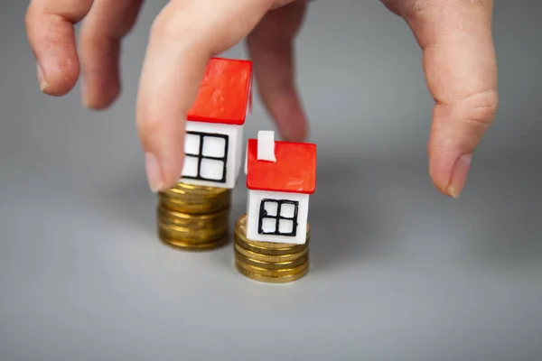 Small Houses Coins Hand Reaches Out Them Buying Selling Real — Stock Photo, Image