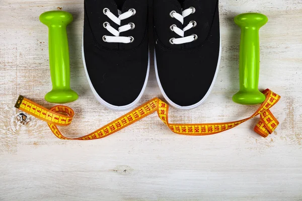 Sneakers, dumbbells and measuring tape — Stock Photo, Image