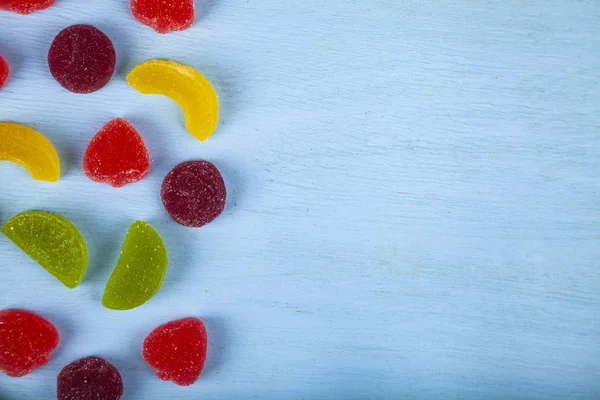 Multicolored marmalade on a blue background — Stock Photo, Image