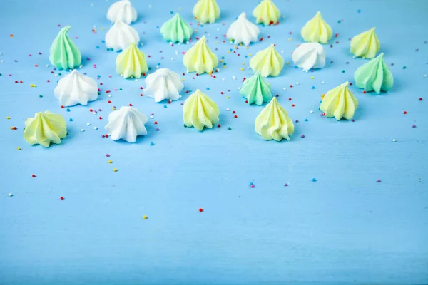 Meringue on a blue  wooden background — Stock Photo, Image