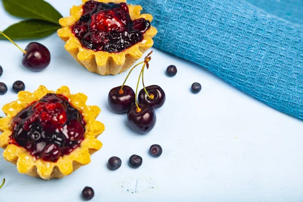 Small berry cake and ripe berries