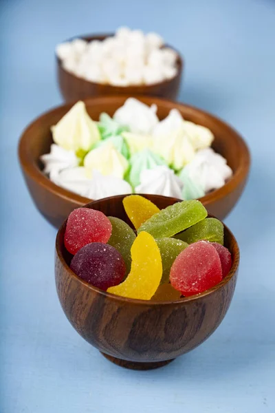 Meringue,marmalade and marshmallow in wooden bowls — Stock Photo, Image