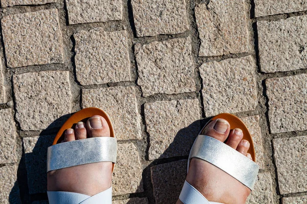 Vrouwelijke Benen Sandalen Een Stenen Stoep Close — Stockfoto
