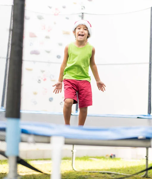 Little Boy Santa Hat Jumping Trampoline — Stock Photo, Image
