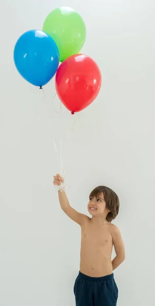 Boy enjoying a bunch of balloons — Stock Photo, Image