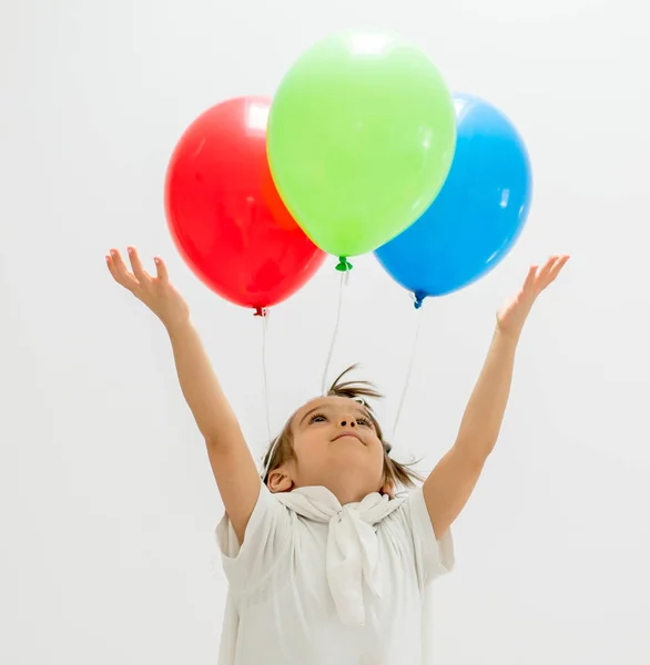 Rapaz feliz com um monte de balões — Fotografia de Stock