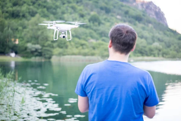Homem na natureza controlando drone voando — Fotografia de Stock