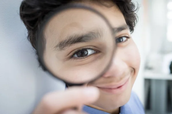 Ragazzo adolescente con lente d'ingrandimento — Foto Stock