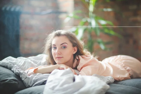 Morning leisure. Serene woman in pajamas relaxing in bed