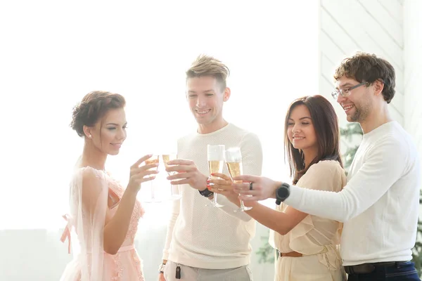 people clanging glasses of champagne together at wedding party