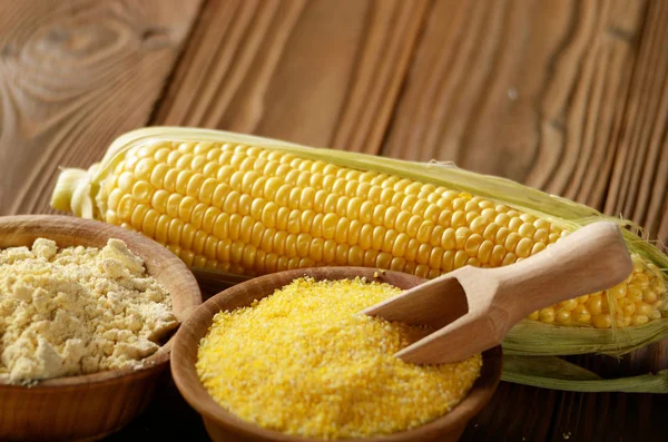 Close up of corn grits in bowl on wooden table