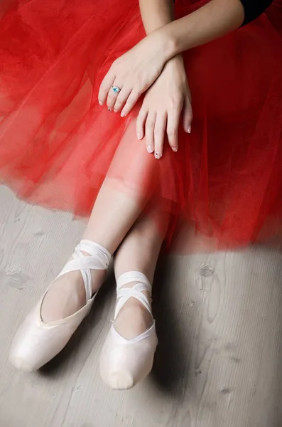 Ballerina\'s crossed hands and feet while rest time