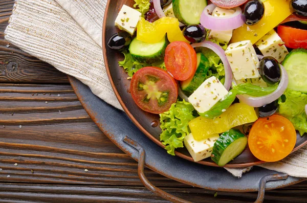 Top view at Mediterranean diet dish greek salad on vintage metal