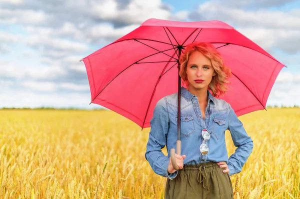 Portrait of attractive young woman with red umbrella — Stock Photo, Image