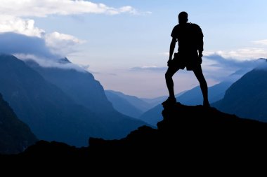 Man hiking success silhouette in mountains clipart
