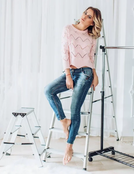 Beautiful young woman in jeans  posing in studio