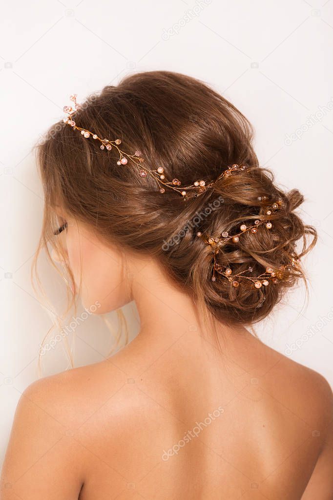Beautiful young  woman posing with hair accessories in studio 