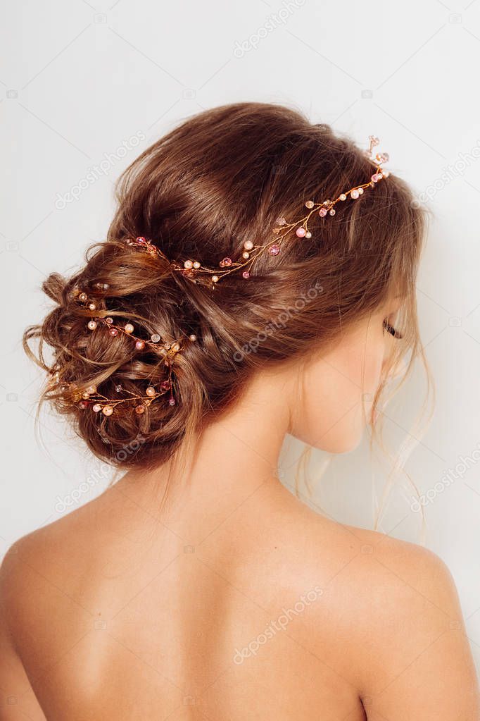 Beautiful young  woman posing with hair accessories in studio 