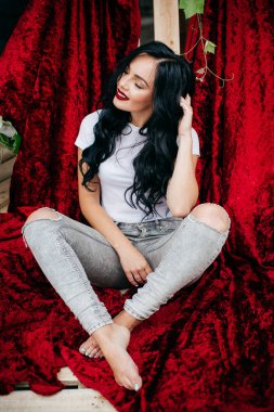 Kot pantolon kadife kumaş arka planı açık poz güzel genç esmer kadın portresi