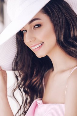 Güzel genç pembe elbise ve şapka poz portresi