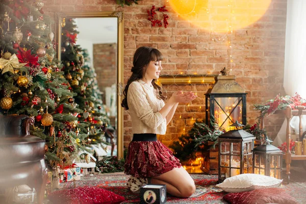 Beautiful woman  near Christmas tree posing at home
